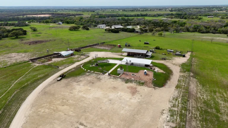 An aerial view of 3 Shy Ranch showing the strategic layout of buildings, open fields, and parking areas designed for efficient site flow during cattle dog trials.
